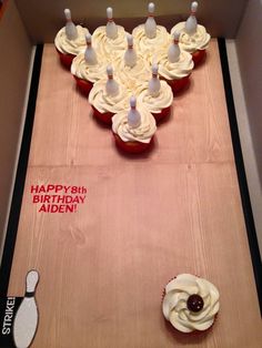 cupcakes in a box with happy birthday written on the side and bowling pins