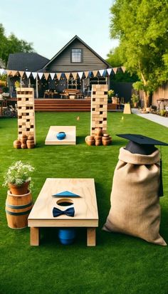 an outdoor game set up on the grass in front of a house with lawn furniture and decorations