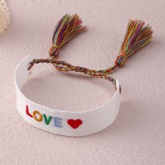 Add a pop of color to your wrist with our Embroidered Boho Tassel Bracelet. Handcrafted with intricate embroidery and stylish tassels, this bracelet is a perfect addition to your boho-chic collection. Shop now and elevate your accessory game with this stylish and trendy bracelet. Bohemian Embroidered Friendship Bracelets For Festivals, Bohemian Adjustable Embroidered Bracelets, Bohemian Embroidered Adjustable Bracelets, Adjustable Embroidered Bohemian Friendship Bracelets, Adjustable Embroidered Multicolor Bracelets, Adjustable Embroidered Multicolor Beaded Bracelets, Adjustable Multicolor Embroidered Beaded Bracelet, Bohemian Multicolor Embroidered Friendship Bracelets, Bohemian Adjustable Embroidered Beaded Bracelets