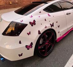 a white car with pink butterflies painted on it