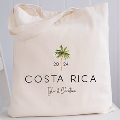 a tote bag with the name costa rica on it and a palm tree logo