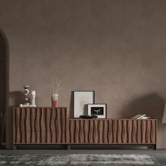 a living room with a large wooden cabinet and lamp on the sideboard next to it