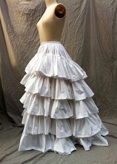 This Ruffled Petticoat is a full petticoat gathered into the waistband. It has five 9 ruffles. This petticoat can be worn in a variety of ways: Fitted Full Skirt Petticoat With Ruffles, Fitted Full Petticoat With Ruffles, Full Skirt With Ruffles In Crinoline, Cosplay Petticoat With Attached Cancan, Full Crinoline Skirt With Ruffles, Ruffled Tiered Skirt Petticoat For Costume Party, Fitted Petticoat With Gathered Skirt For Costume Party, Costume Petticoat With Tiered Skirt, Fitted Gathered Petticoat For Costume Party