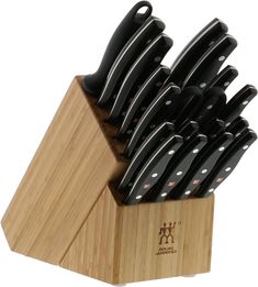 a set of knives sitting on top of a wooden block