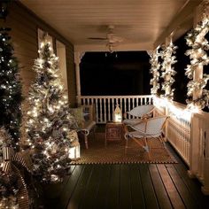 the porch is decked out with christmas trees