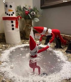 two elfs in the bathroom playing with snow