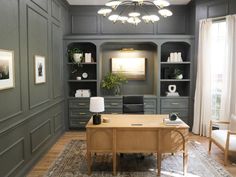 a living room with gray walls and wooden furniture in the center, along with an area rug on the floor