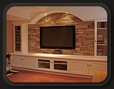 a large flat screen tv mounted to the side of a wall in a living room