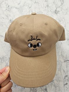 If you love Stray Kids and therefore Skzoo, this was made for you. Perhaps the CUTEST way to rep your bias in a subtle way. This is made from a 100% chino cotton twill brown cap.  If you have more than one bias (which who doesn't), or want to match with someone else, I do have the whole skzoo collection up in my shop! Most members I have as both a cap and a bucket hat, so whatever you need, I have covered.  This product is made especially for you as soon as you place an order, which is why it takes us a bit longer to deliver it to you. Making products on demand instead of in bulk helps reduce overproduction, so thank you for making thoughtful purchasing decisions! Playful Brown Cap Hat, Playful Brown Cap, Cute Hats With Embroidered Logo And Curved Brim, Fun Cap With Embroidered Logo, Fun Embroidered Logo Cap, Cute Adjustable Baseball Cap With Short Brim, Cute Embroidered Adjustable Baseball Cap, Cute Baseball Cap With Embroidered Logo, Cute Adjustable Baseball Cap With Embroidered Logo