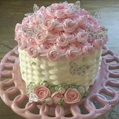 a pink and white cake sitting on top of a table