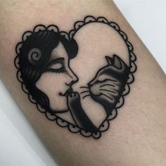 a woman's face in a heart shaped frame with a cat on her arm