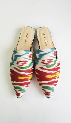 Crafted by artisans skilled in the great Turkish shoemaking tradition, our handmade ikat mules are crafted of genuine leather soles and only the finest natural cotton kilim, raw silk and silk velvet textiles available. As each of our stunning ikat mules are made by hand, no two pairs are exactly alike. Thus, each pair of these luxury mules is entirely unique -- just like you! Our luxury ikat mules are available in a wide array of colors and patterns, in both rounded and pointed toe-styles. We of Multicolor Pointed Toe Mules For Summer, Traditional Summer Mules With Pointed Toe, Pointed Mules, Pointed Flats, Stunning Shoes, Flat Mules, High Quality Shoes, Silk Velvet, Mule Flat