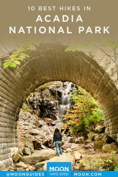 a person standing under a stone bridge with text overlay reading 10 best hikes in acadia national park