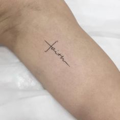 a person's arm with a tattoo that says faith on the left side of their arm