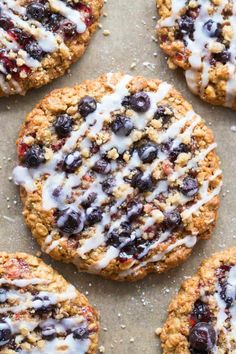 blueberry oatmeal cookies with white icing on a baking sheet ready to be eaten