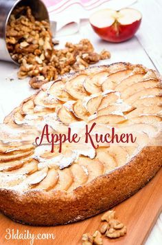 an apple cake on a wooden cutting board