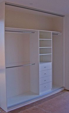 an empty white closet with drawers and shelves