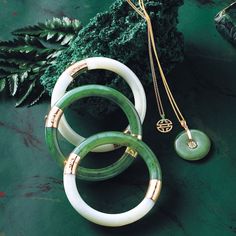 Since 1861, Gump's has been a destination for jewelry that is distinctive, extraordinary and timeless — and our jade collection is no exception. Once considered more precious than gold, jade has been more highly prized in Asia than any other gemstone. Treasured for thousands of years, it represents harmony, balance and protection, and is thought to bring good luck to the wearer. Green nephrite jade. 14-karat yellow gold. Fits wrists up to a size 7 1/2". Chinese Jade Necklace Pendants, Luxury Green Carved Jewelry, Luxury Jade Emerald Necklace With Round Beads, Luxury Beaded Jade Necklace, Green Stone Necklace New Zealand, Jade Pendant Necklace Simple, Luxury Green Round Pendant Jewelry, Luxury Jade Bracelets, Jade And Gold Jewelry