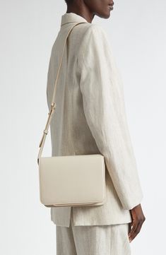 Clean-lined Danish design and extraordinary craftsmanship add to the timeless look of this calfskin-leather crossbody bag with room for just the essentials. Magnetic-snap flap closure Adjustable crossbody strap Leather Made in Italy Designer Handbags Black Owned/Founded Evening Shoulder Bag With Smooth Grain In Beige, Beige Smooth Grain Shoulder Bag For Evening, Evening Beige Smooth Grain Shoulder Bag, Beige Rectangular Shoulder Bag With Smooth Grain, Cream Rectangular Shoulder Bag With Smooth Grain, Luxury Neutral Crossbody Shoulder Bag, Modern Rectangular Neutral Shoulder Bag, Modern Neutral Rectangular Shoulder Bag, Timeless Beige Rectangular Flap Bag