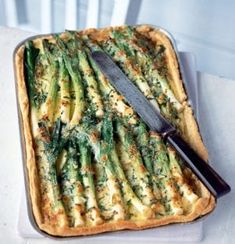 a square casserole dish with asparagus and cheese