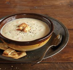 a bowl of soup and crackers on a plate