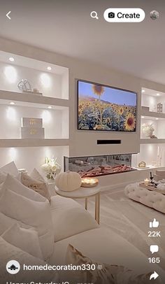 a living room filled with white furniture and a flat screen tv mounted to the wall