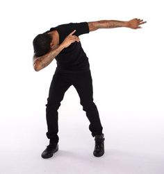 a man in black shirt and jeans doing a trick with his arms out to the side