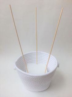 several sticks sticking out of a white bowl