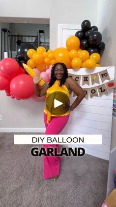 a woman standing in front of balloons with the words diy balloon garland on it