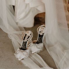 the bride's wedding shoes are sitting on the floor in front of her veil