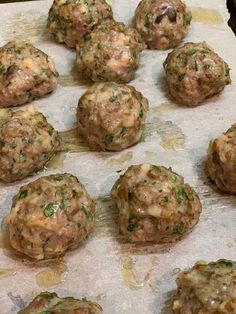 a bunch of meatballs sitting on top of a piece of wax paper