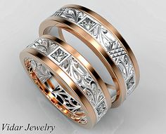 two gold and silver wedding bands with intricate engraving on each band, set against a white background