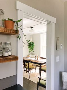 an open door leading into a dining room