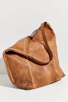 NWT FREE PEOPLE X GIORGIO BRATO WASHED SLOUCHY TOTE BAG IN COGNAC. Made to be worn with everything, this go-to bag is featured in a buttery soft leather and bucket-inspired silhouette with a fixed shoulder strap, spacious interior compartment, and secure magnetic closure. Slouchy style Fully lined interior Bucket-shaped silhouette Height: 18.5 in Width: 16 in Bottom: 8 x 11.5 in Care/Import Made in Italy Contents Leather Large Handbags Leather, Slouchy Tote Bag, Soft Leather Hobo Bag, Slouchy Tote, Slouchy Style, Large Leather Tote, Recycled Leather, Hobo Bag, Magnetic Closure