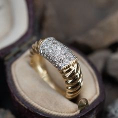 This intriguing 18K yellow gold ring features a fluted design and is accented with nineteen (19) round brilliant cut diamonds bead set into 18K white gold. The ring measures 8.2mm at the top, rises 4.3mm above the finger, tapering to 4.2mm wide and 1.2mm thick at the base of the shank. The ring is currently size 6.75. Bead Set, 18k Yellow Gold Ring, Yellow Gold Ring, Round Brilliant Cut Diamond, High Quality Jewelry, Modern Jewelry, Brilliant Cut Diamond, Yellow Gold Rings, Estate Jewelry