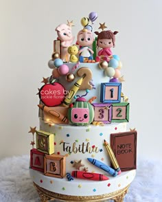 a birthday cake decorated with children's toys and numbers on it, sitting on a white furnishing