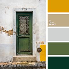 a green door on the side of a white building with yellow and gray paint swatches