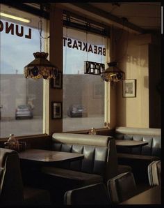 the inside of a restaurant with tables and chairs in front of large windows that read breakfast