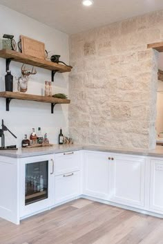 a kitchen with white cabinets and open shelves