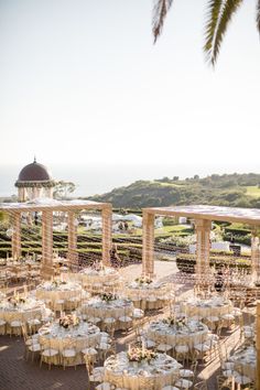 an outdoor wedding venue with tables and chairs