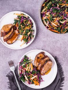 two white plates with meat and vegetables on them