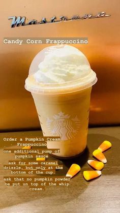 a cup of coffee with candy corn on the side and an advertisement for starbucks's milkshake