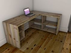 an open laptop computer sitting on top of a wooden desk next to a white wall