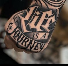 a man's hand with a tattoo that says life is a journey