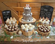 a table topped with lots of cupcakes and cakes