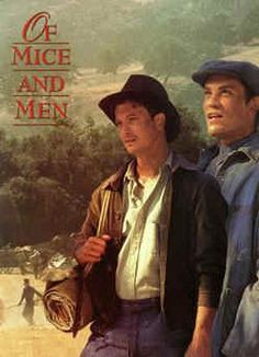 two men standing next to each other in front of a poster for the movie o mice and men