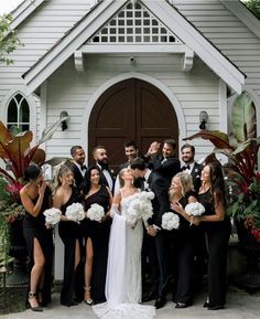 a group of people standing in front of a church