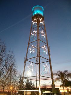 a tall tower with stars on it at night