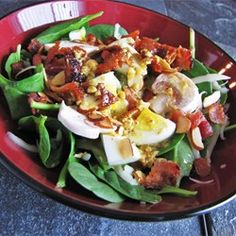 a red plate topped with salad and hard boiled eggs