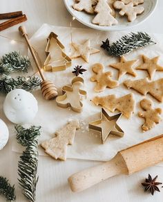 some cookies are on a table next to other christmas decorations and baking utensils